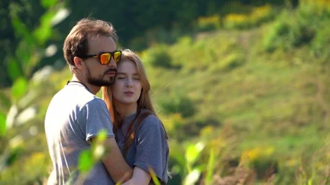 Young couple hugging each other and looking away Stock Footage 246838833
