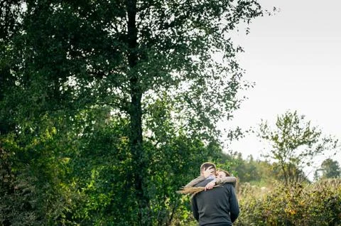 Young couple hugging in a forest Stock Photos