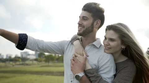 Young couple hugging in park Stock Footage 106316659