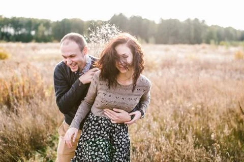 Young couple hugging at sunset Stock Photos