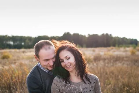 Young couple hugging at sunset Stock Photos