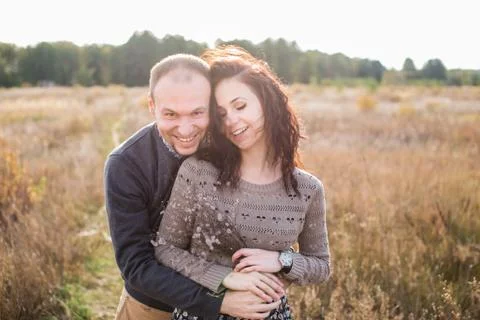 Young couple hugging at sunset Stock Photos
