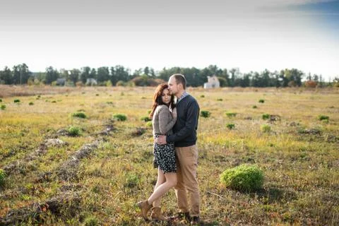 Young couple hugging at sunset Stock Photos