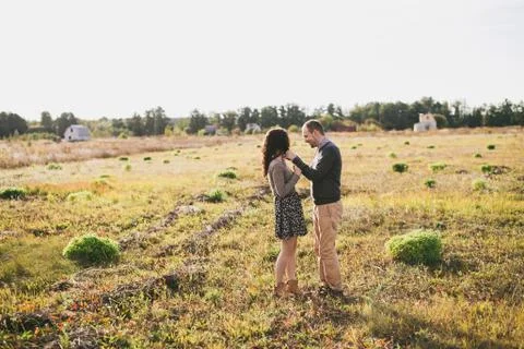 Young couple hugging at sunset Stock Photos