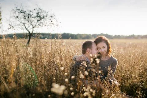 Young couple hugging at sunset Stock Photos