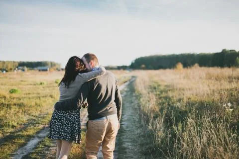 Young couple hugging at sunset Stock Photos