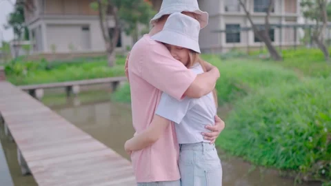 Young couple hugging while looking at each other standing at home at dawn  Stock Footage 265052526