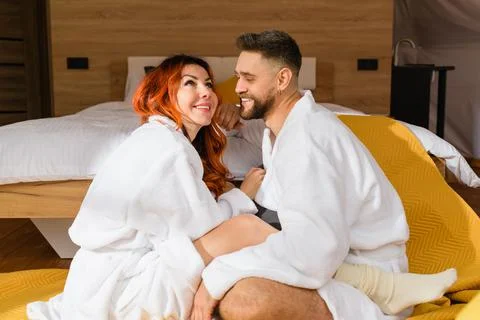 Young couple hugging while sitting face to face Stock Photos