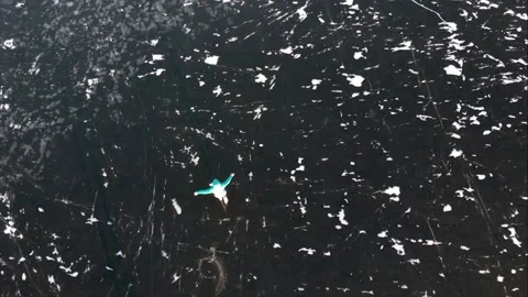 Young couple ice skating in winter outdoors on a frozen lake in Canada Stock Footage 166824558