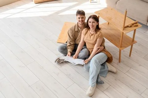 Young couple with instructions assembling shelf unit at home Stock Photos