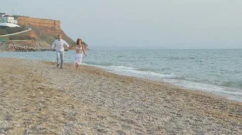 Young Couple Jogging On Beach Video stock 22418810
