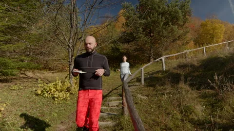 Young couple jogging down the stairs in autumn. Running towards the camera, girl Stock Footage 167337149