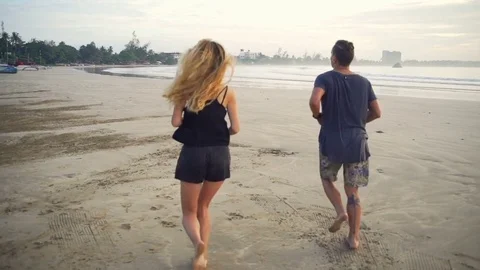 Young couple jogging on the empty beach morning time rapid slow motion Stock Footage 84883191