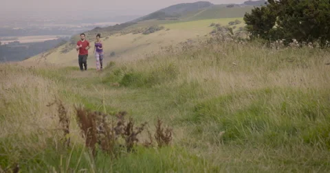 Young couple jogging in field Stock Footage 59899973
