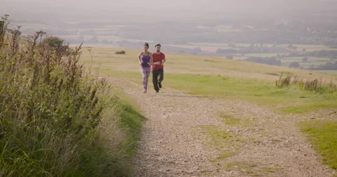 Young couple jogging in field Stock-Footage 59900012