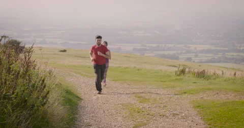 Young couple jogging in field Stock-Footage 59900014