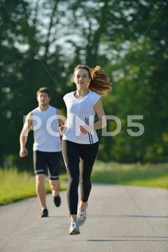 Young couple jogging at morning Stock Photos