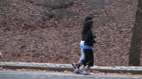 Young Couple Jogging Through Central Park Stock Footage 59568127