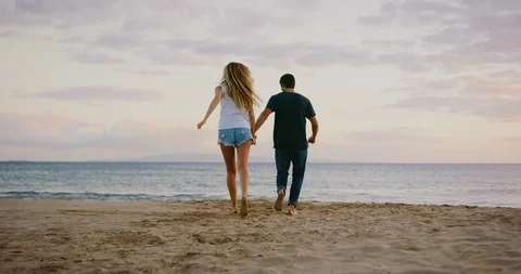 Young couple jumping joyfully together Stock Footage 106518012