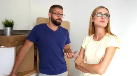 Young couple just move to their new apartment. They are arguing about unpacking. Stock-Footage 54732405