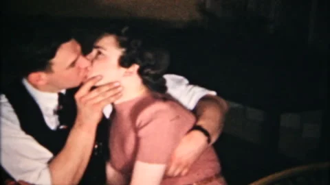 Young couple kiss for the camera at home 1950s family home movie 6265 Stock Footage 144888294