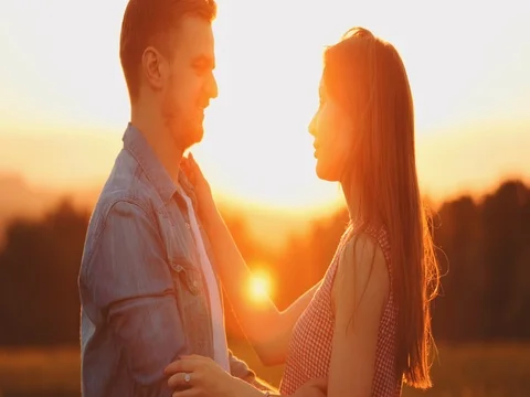 Young Couple Kissing at Sunset. SLOW MOTION 4K, Close Up. Cinematic backlit shot Stock Footage