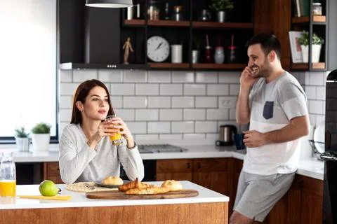 Young couple in the kitchen with breakfast Stock Photos