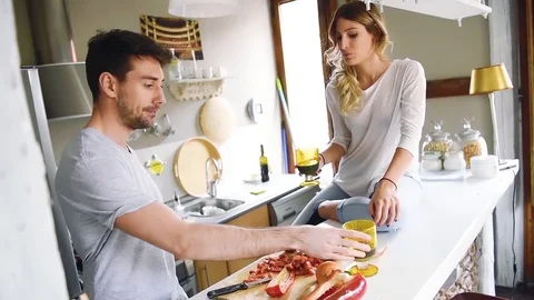 Young couple at kitchen cooking and drinking wine Stock Footage 74728443