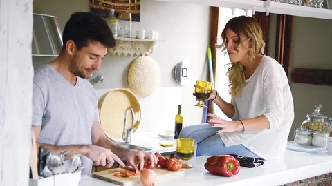 Young couple at kitchen cooking and drinking wine Stock Footage 74728565