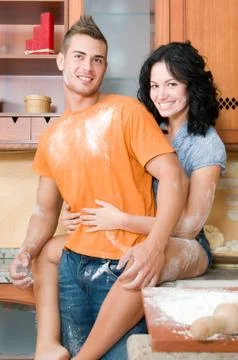 Young couple in the kitchen having fun with flour Stock Photos