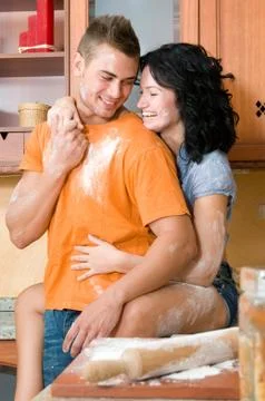 Young couple in the kitchen having fun with flour Stock Photos