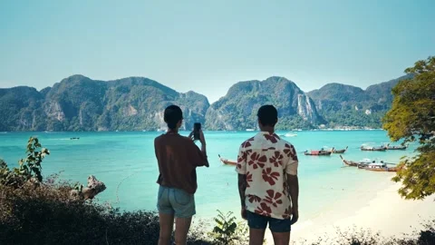 Young couple in Koh Phi Phi in Thailand taking pictures of the beautiful Stock Footage 334672228