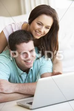 Young couple on laptop computer Stock Photos