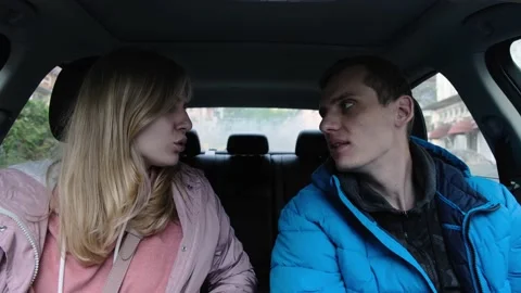 Young couple laughs at first and then swears while sitting in car Video stock 132277044