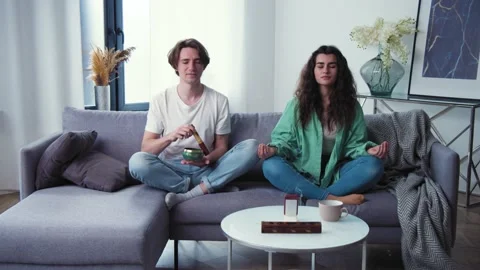 Young couple learning to care mental health. Family try meditation with tibetan Stock Footage 152904396