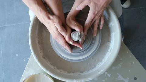 Young couple is learning to work at a potter's wheel Stock-Footage 169572429
