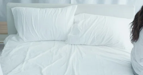 A young couple lie down on the bed in the opposite direction Stock Footage 100937934