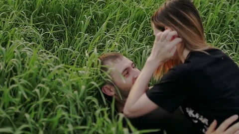 Young couple lies on the grass Stock Footage 79610281