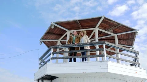 Young couple at the lighthouse together looking through binoculars. Stock-Footage 74910533