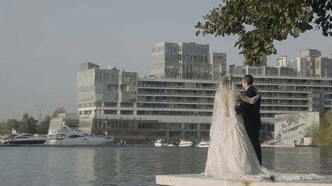 Young couple look at the river standing at the pier rear view Stock Footage 124277639