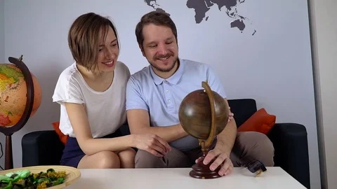 Young couple look the world map to decide the next trip Stock Footage 74862712