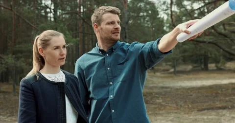 Young couple looking and choosing a plot of land for house construction Stock Footage 152204496