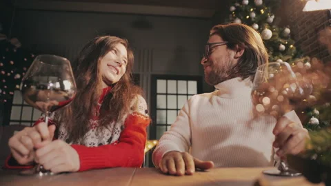 Young couple looking to camera, waving hands and celebrating xmas via video chat Video stock 143274934