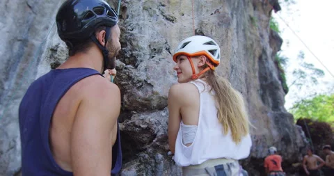 Young couple looking up cliff before climbing up on Railay beach Thailand. Trave Stock Footage 201095131
