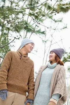 Young couple looking at each other in a park in winter Stock Photos