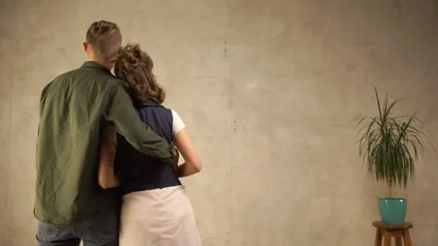 A young couple looking at just finished wall. 動画素材 144865944