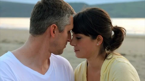 Young couple looking into lovingly into each others eyes at the beach. 스톡 동영상 88406697