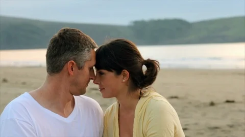 Young couple looking into lovingly into each others eyes at the beach. 스톡 동영상 88406710