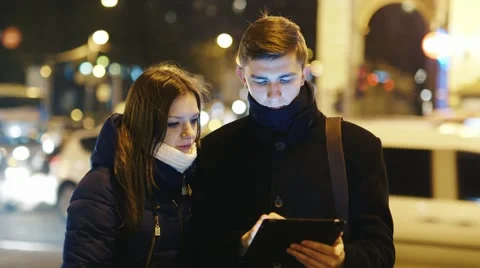 Young couple looking map of the city on the tablet Stock Footage 58454343