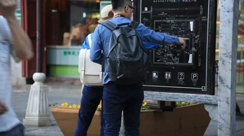 Young couple looking at the map of Dali old town Stock Footage 51719047